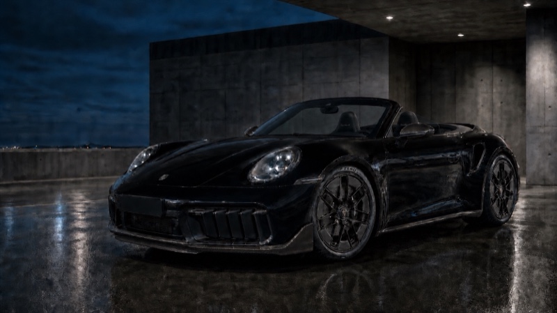 Schwarzes Porsche 911 Turbo S Cabriolet mit geöffnetem Verdeck in einer Betongarage